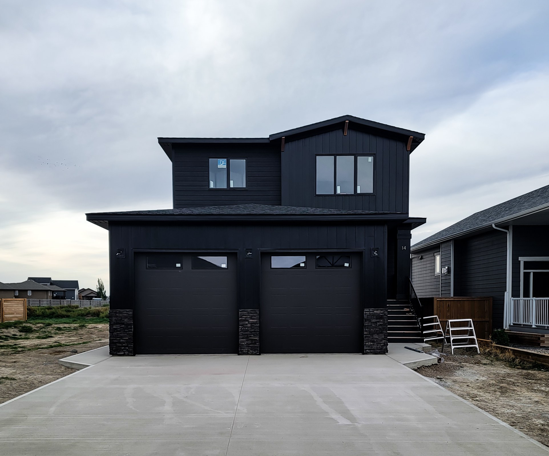 Completed dark-sided two-storey home and attached garage